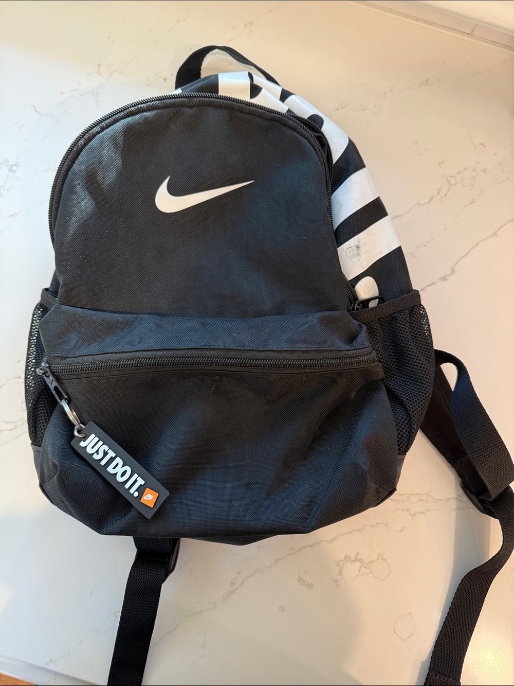 Small Nike Black Backpack with White Swoosh and Stripe Accent